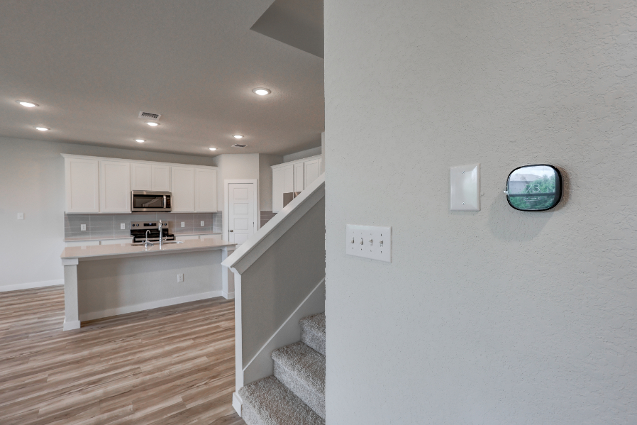 A kitchen with white cabinets.