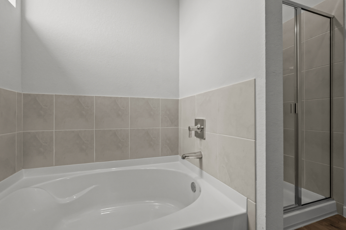 A bathtub in a bathroom.