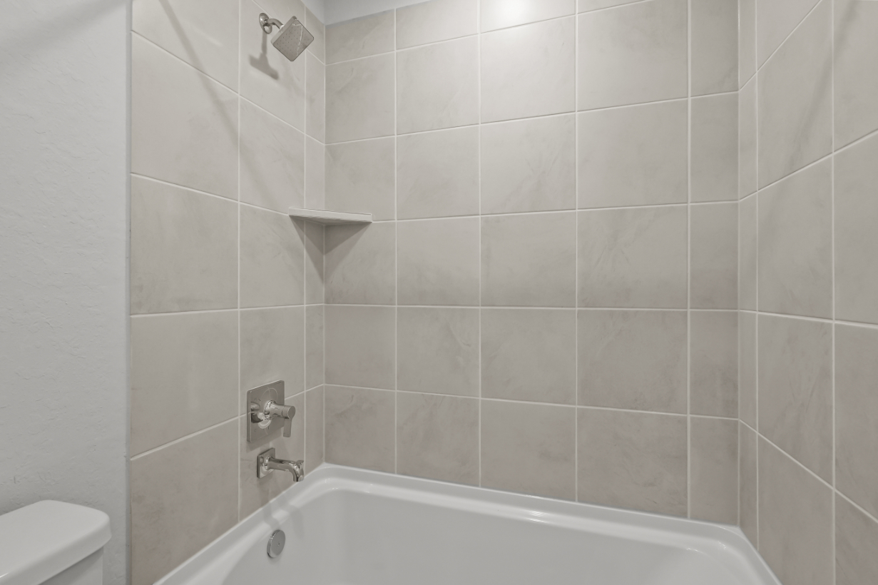 A white tiled bathroom.