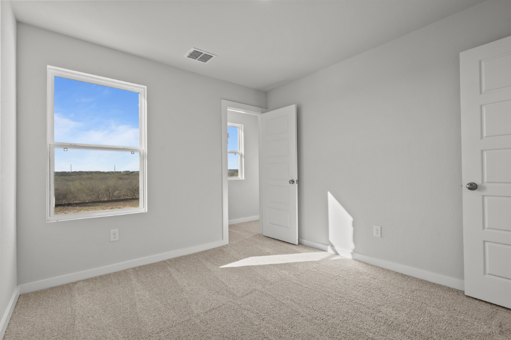 A room with white walls and a window.