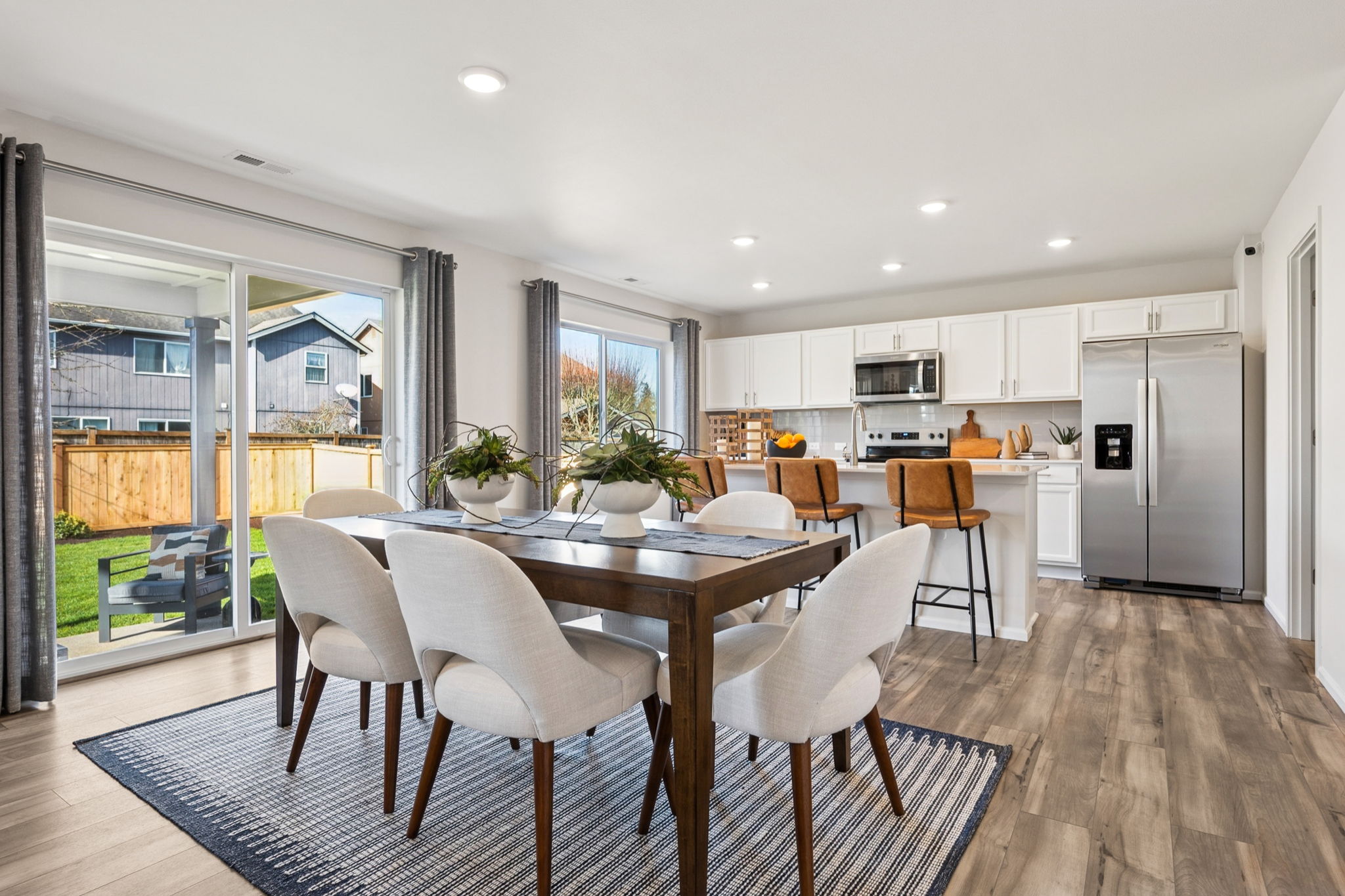 A kitchen with a dining table and chairs.