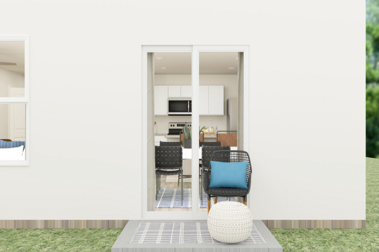 A room with a table chairs and a glass door.