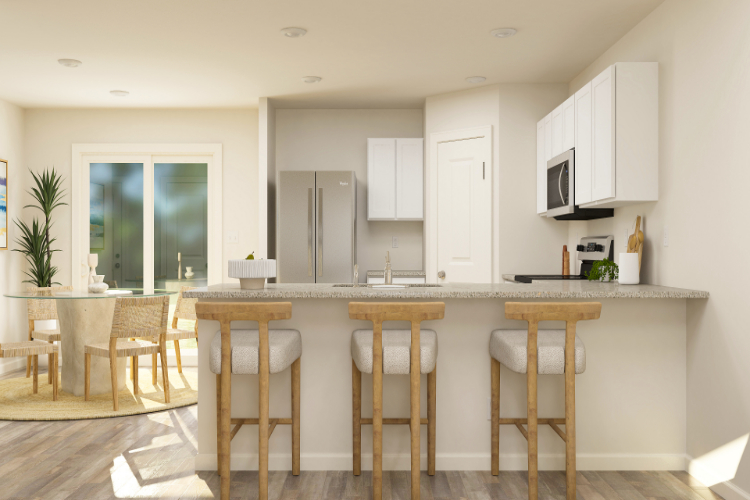 A kitchen with a table and chairs.