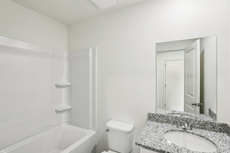 A bathroom with a marble countertop.