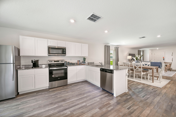 A kitchen with white cabinets.