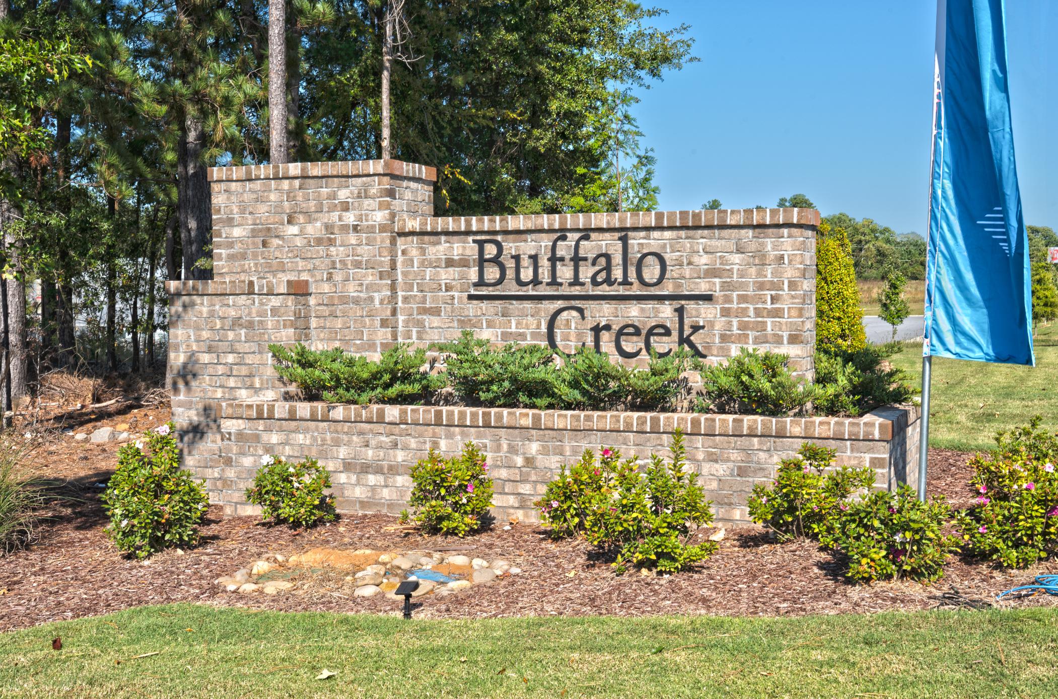 A sign on a brick wall.