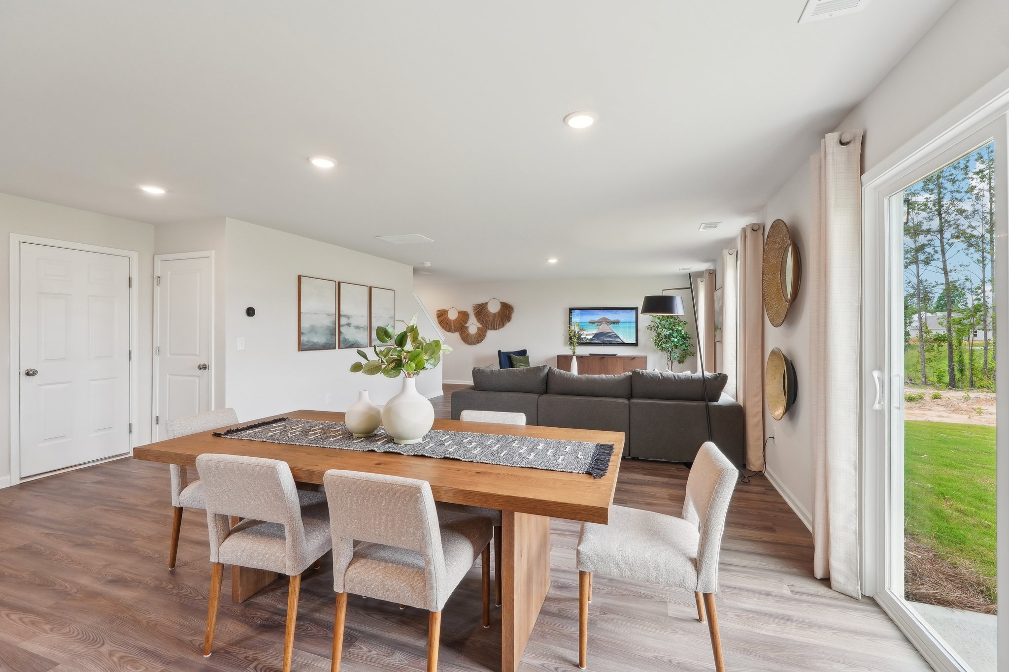 A living room with a large table and chairs.